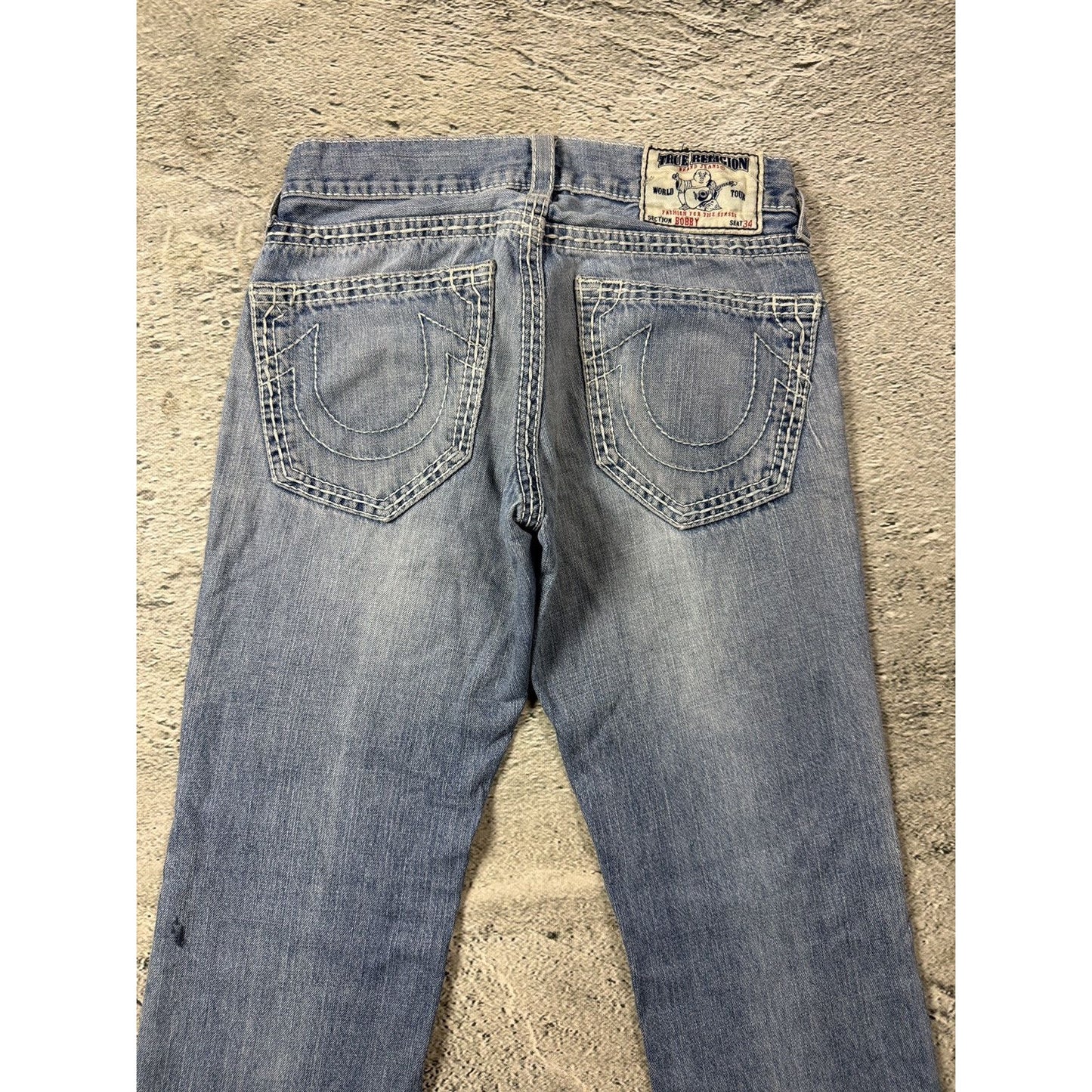 True Religion washed light blue jeans white stitching Bobby